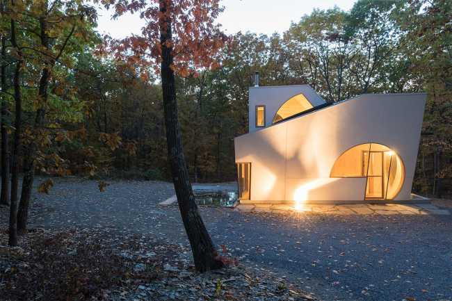 Wooden house lighting in the woods